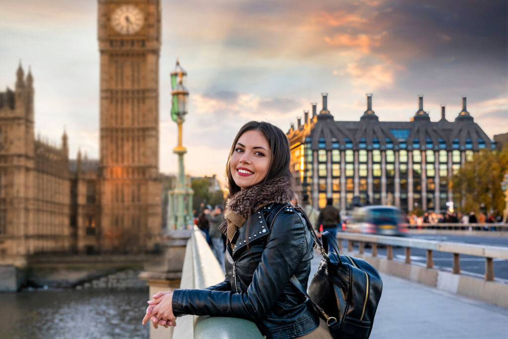 Atrakcyjna, młoda, kobieta podróżnik w Londynie cieszy się widokiem na Westminster Palace i Big Ben clocktower zwiedzanie miasta