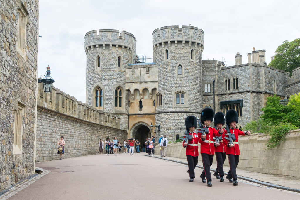 Berkshire, England - 21 July 2016 : Windsor guard in red uniform walking around Windsor castle, Berkshire, United Kingdom on 21 July 2016