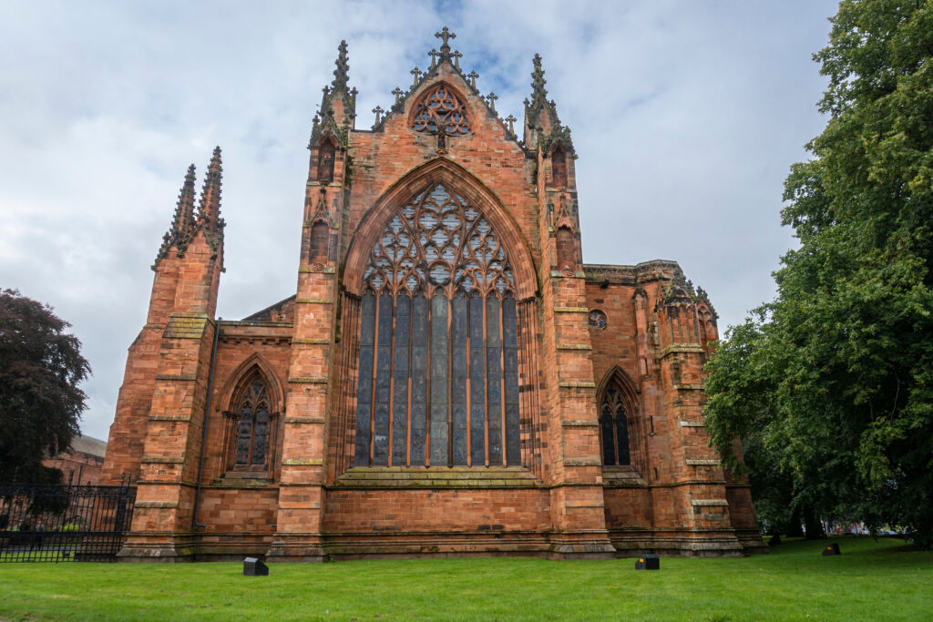 Facade of the red bricked cathedral in the city of Carlisle, UK