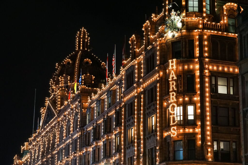 London, England, November 2019: Harrods department store illuminated at night, UK