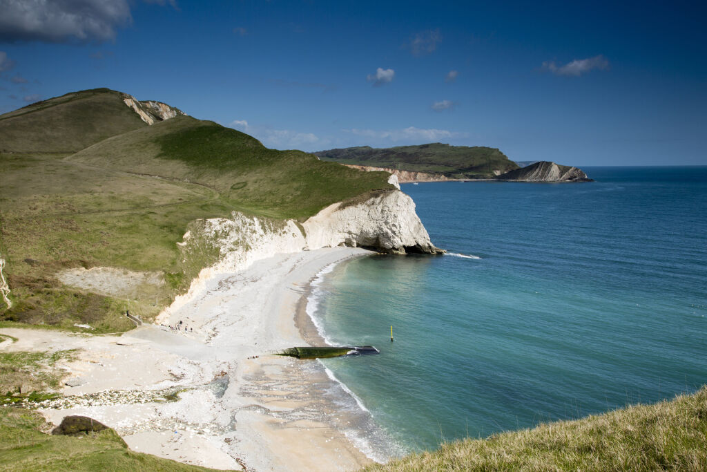 Purbeck ranges coastal path, white cliffs and rocky outcrops in the sea