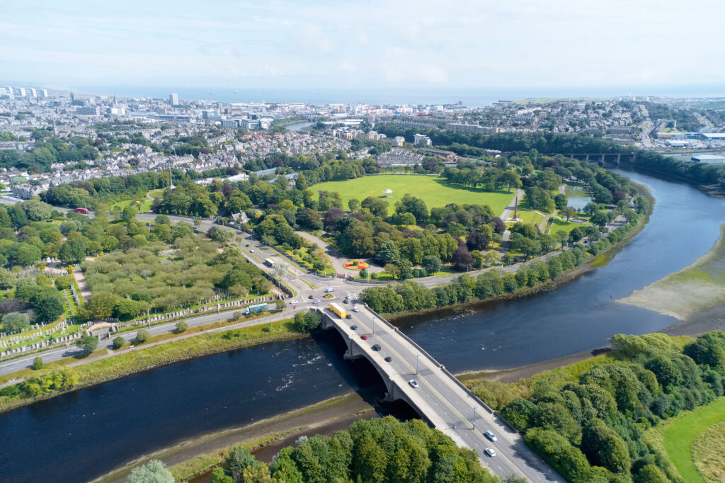 Aerial view of Aberdeen as River Dee flows in a curve to the North Sea showing Duthie Park with bridge and traffic from south