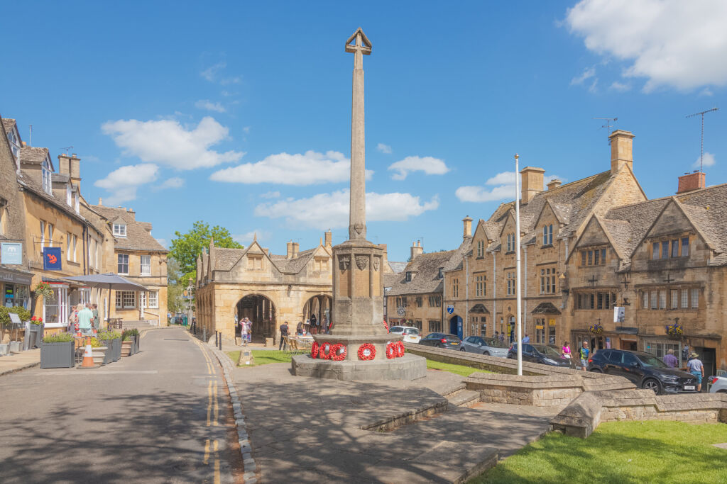 Chipping Campden, UK - June 12 2021: The historic main square with wwi war memorial and old town market hall in the quaint English village of Chipping, Gloucestershire, England.