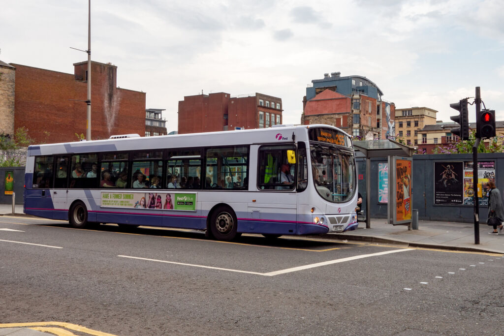 GLASGOW, SCOTLAND - JULY 31, 2019:   Volvo B7RLE city bus of the First Glasgow transportation company at the bus stop in front of traffic lights