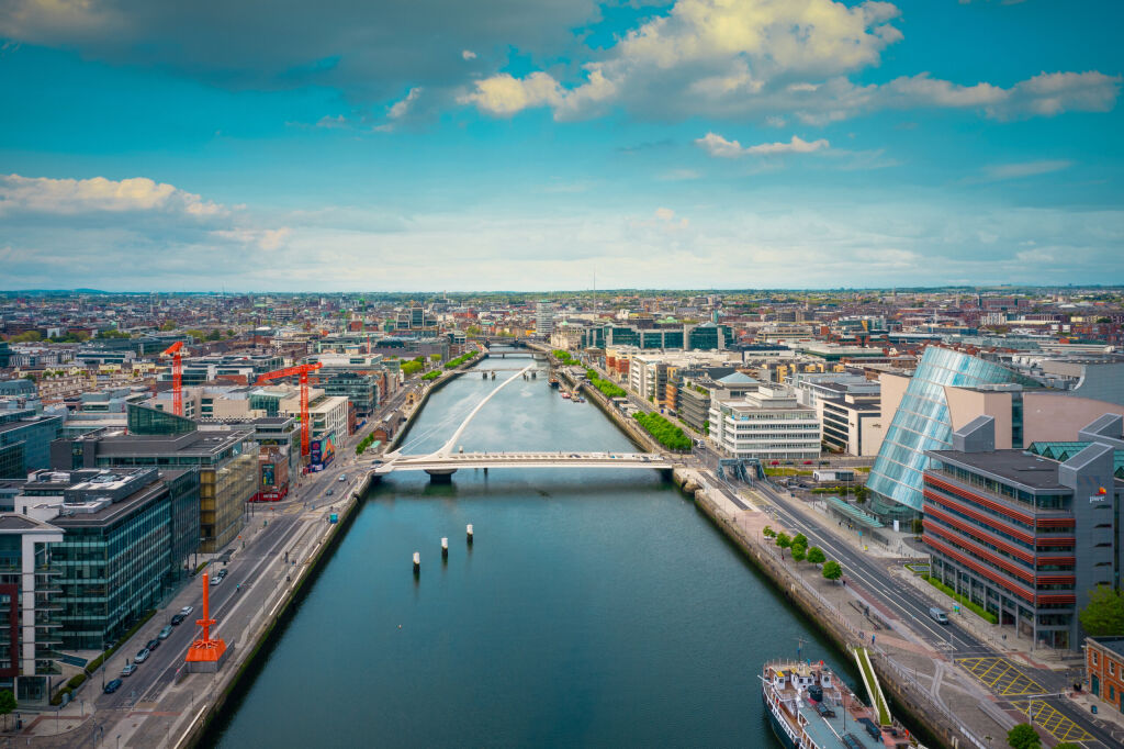 Dublin / Ireland - May 2020: Aerial view of Dublin city center at sunset with River Liffey and Samuel Beckett bridge in the middle. Bridge designed by Santiago Calatrava