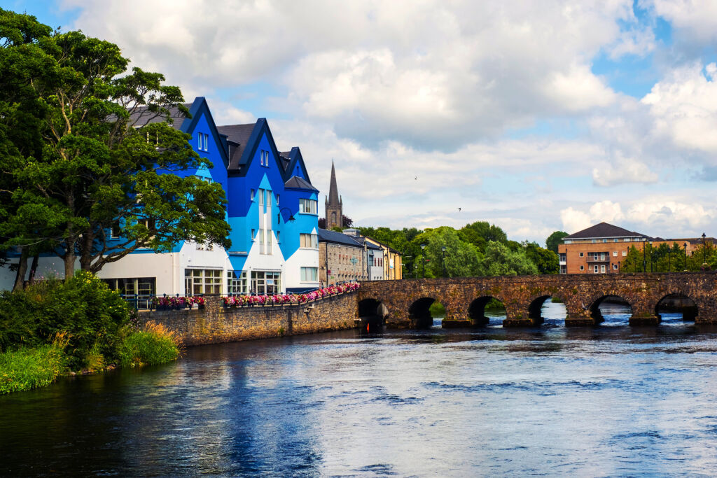 Sligo, Ireland. Beautiful landscape in Sligo, Ireland with river and colorful houses. Cloudy sky in summer, old bridge over the river